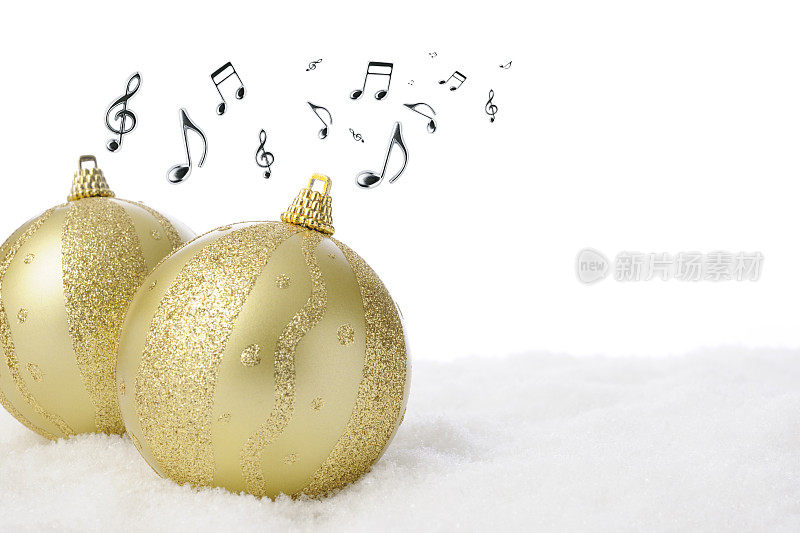 雪花上两个金色的圣诞球，带着悦耳的音符