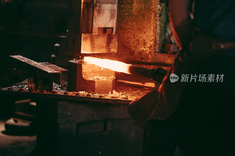 在铁匠的锻炉中机械锤击灼热的铁