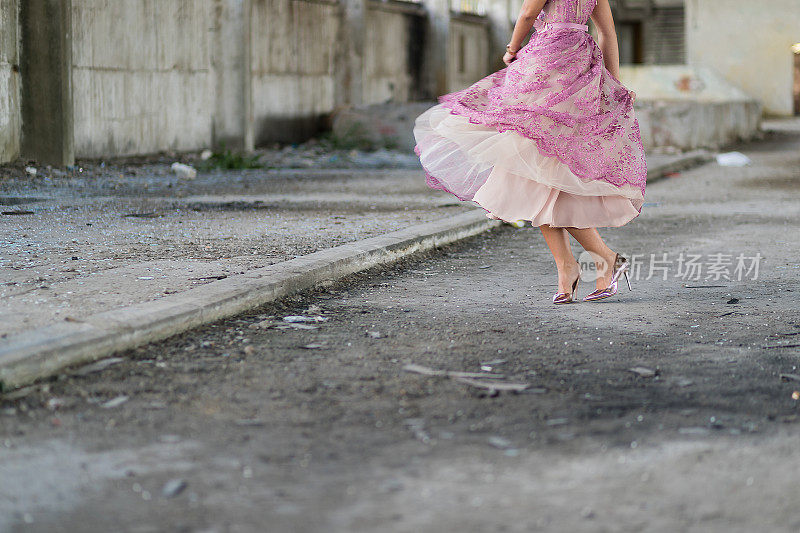 美丽的女人穿着优雅的衣服在废弃的建筑里