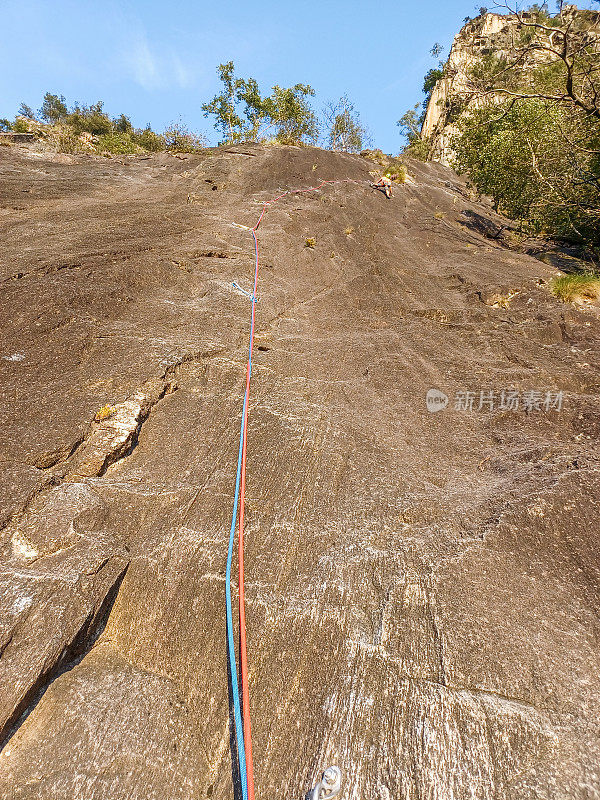 远处的登山者登上岩壁