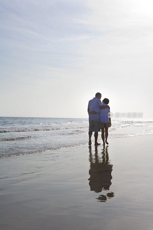 老年夫妇在沙滩上散步