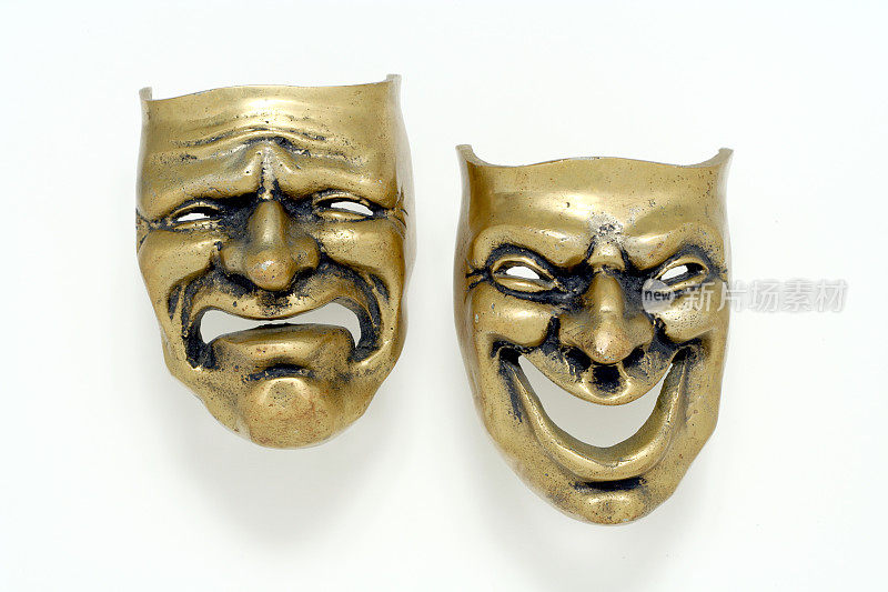喜剧和悲剧的黄铜面具在白色的背景