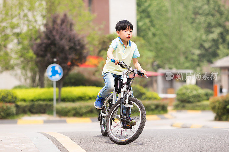 小学生在一个安静的小区里骑自行车