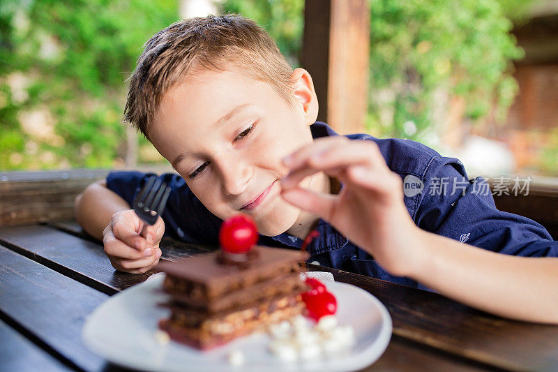 小男孩正在吃巧克力蛋糕