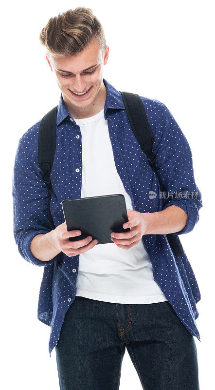 白人少年穿着裤子站在白色背景前使用数码平板电脑