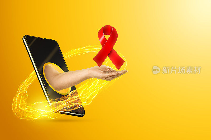 在黄色背景下，手持一条红丝带横跨智能手机屏幕。艾滋病日概念，复制空间。