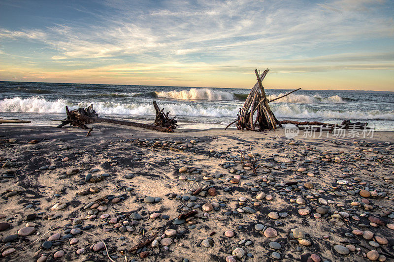 原始的海滩小屋在一个偏远的海滩上，海浪冲击在白鱼点的海岸密歇根
