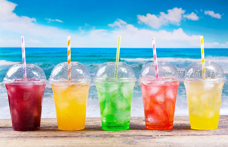 海滩上五颜六色的塑料杯冷饮