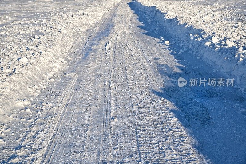 结冰的湖面上覆盖着冰雪的道路