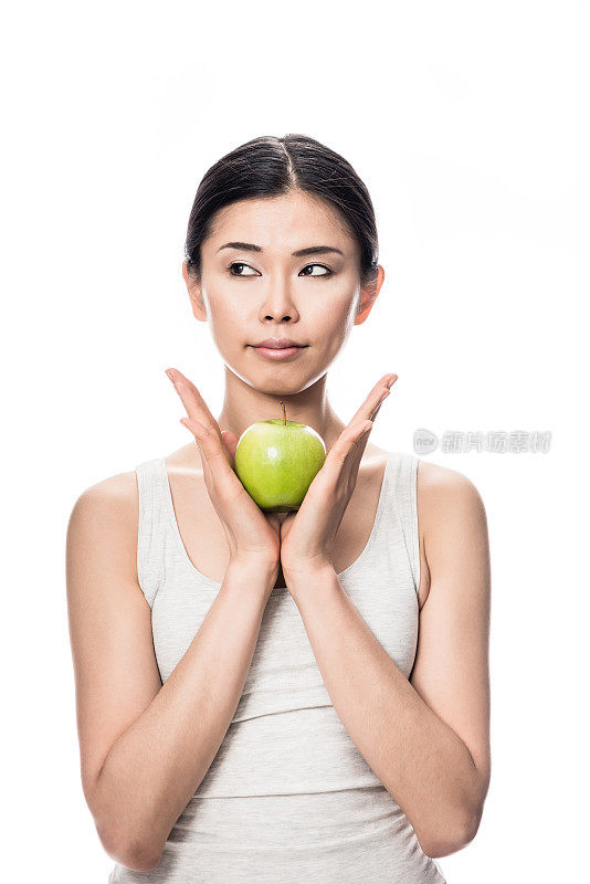 体贴的年轻亚洲女人拿着一个青苹果