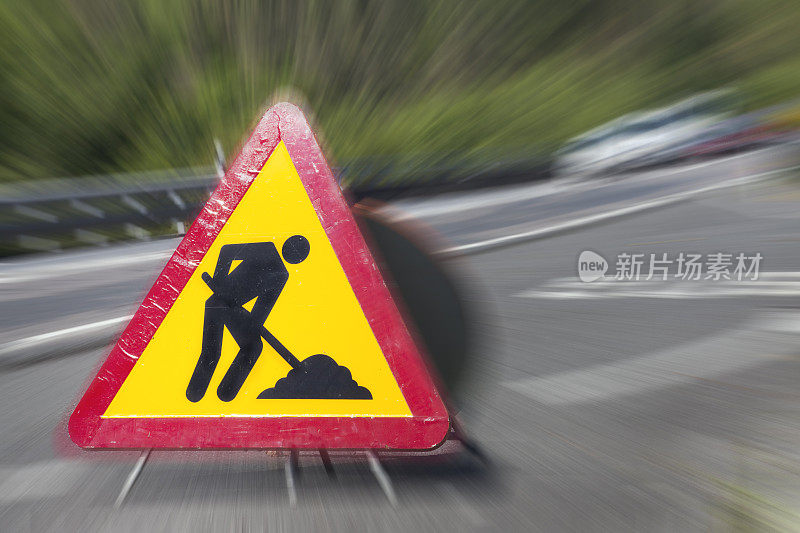 前方道路施工标志，车辆通行，前方危险警告。