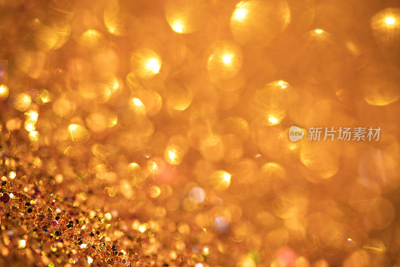 金色闪烁的灯光散景抽象背景假日