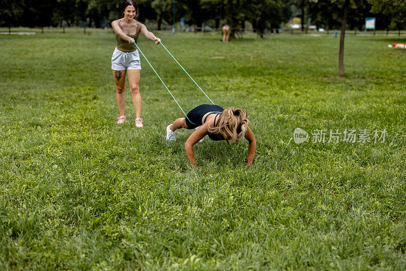 带着阻力带在草地上做俯卧撑