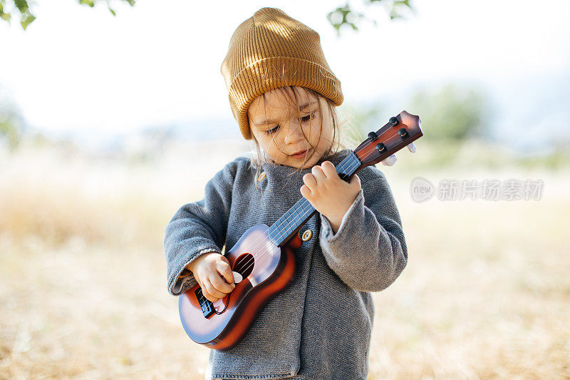 小女孩在弹吉他