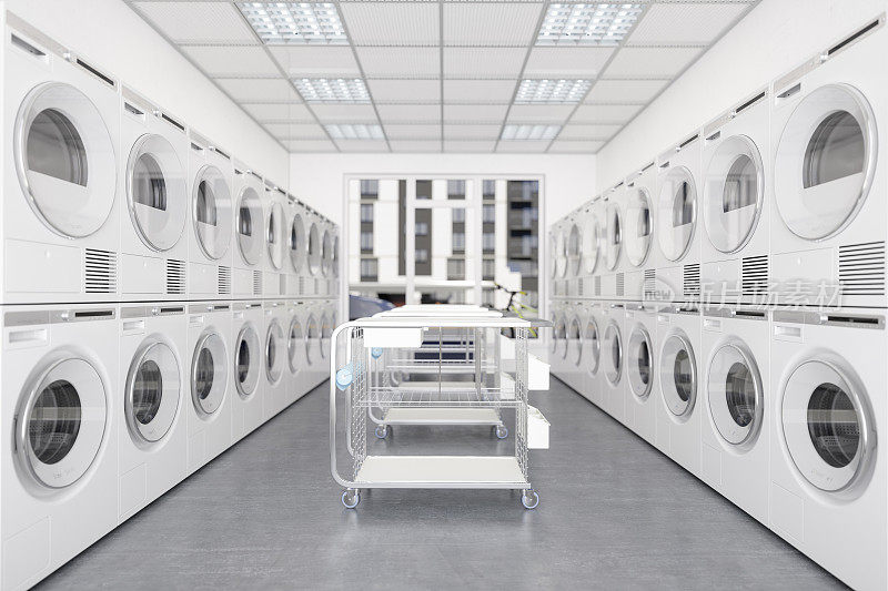 白色洗衣机和烘干机在一排与轮式洗衣篮。