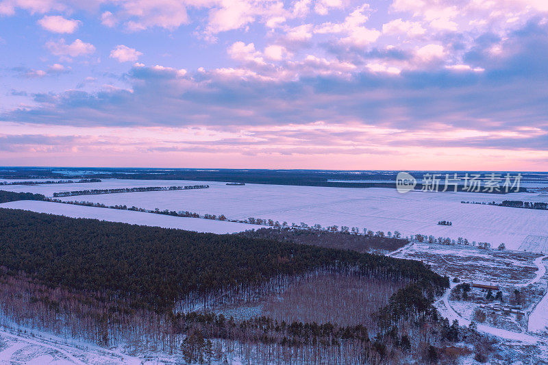鸟瞰图的冬天下雪的乡村在日落