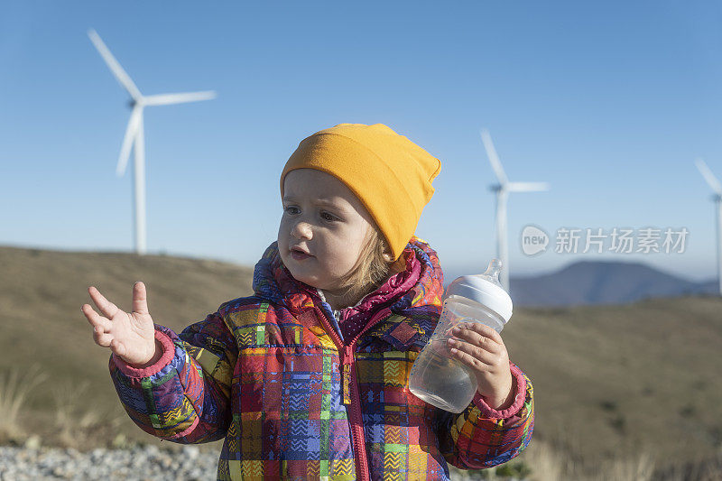 孩子在山上的风能公园，四处张望。