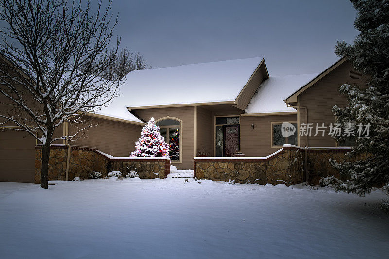 魔法光照亮白雪覆盖的树和家圣诞节早晨。