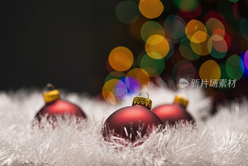 三个红色的小玩意，白色的花环和三焦圣诞树。