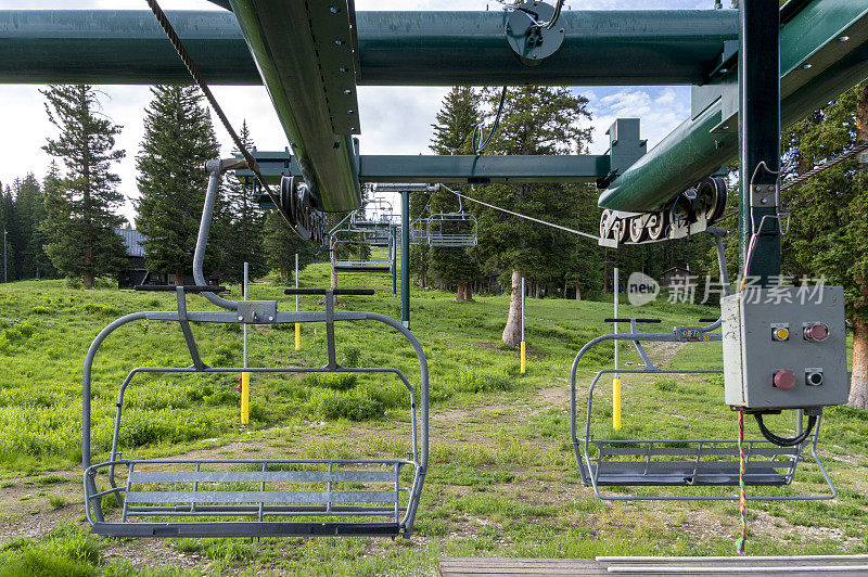 在夏季的绿色山上的空滑雪缆车