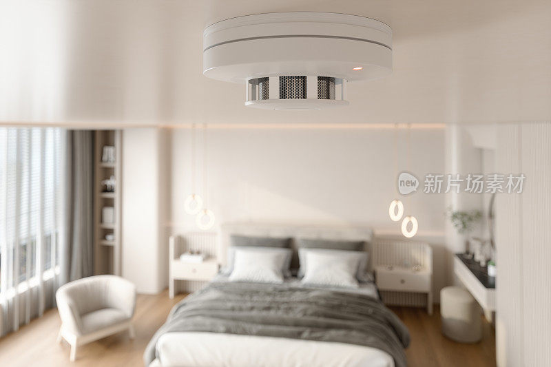 烟雾探测器在天花板与模糊卧室背景的特写视图