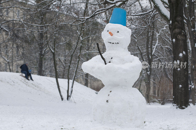 在公园里玩雪人和滑雪橇