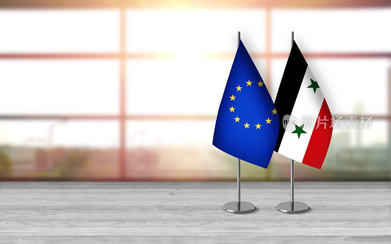 叙利亚和欧盟的3D桌面旗帜同时放在一张桌子上，背景阳光明媚，有很大的拷贝空间。