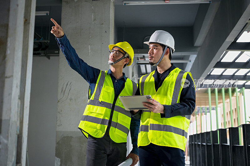 土木工程师和建筑监理在施工现场检查建筑物的内部结构。建筑工程师或建筑师和工头检查建筑物内部的结构。