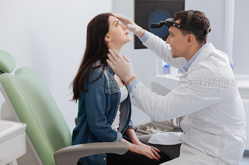 耳鼻喉科医生正在检查病人的鼻子