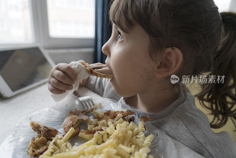 小女孩正在吃鸡肉