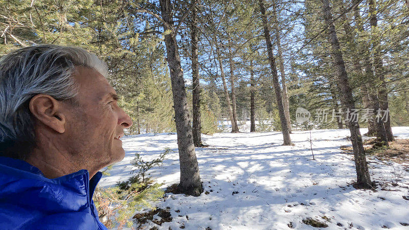 成熟的夫妇走在雪山小路上