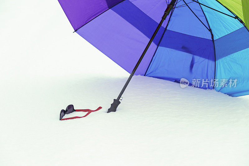 雪中的雨伞和太阳镜