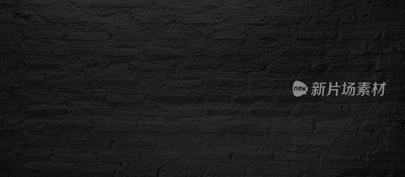 近距离的grunge深黑色砖墙在最小的风格。黑色空砖墙为工业概念，留白为设计空间。
