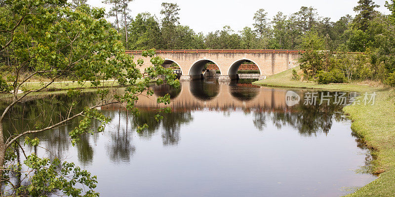 桥上的运河和池塘在前景。反射的水。