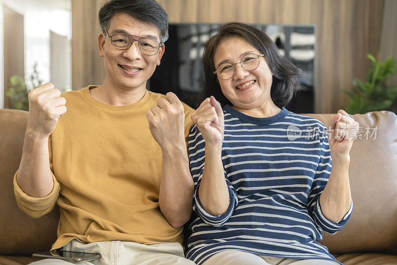 肖像亚洲幸福老年夫妇休闲布坐轻松休闲居家隔离新常态生活方式，居家强健康与亚洲老年人居家