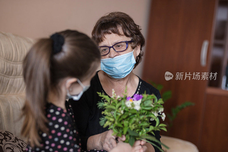 快乐的老女人从一个女孩那里收到花