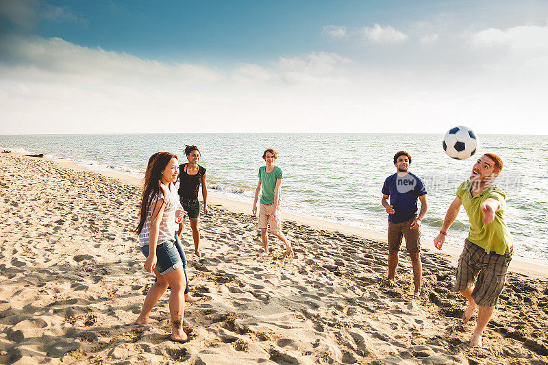一群朋友在沙滩上打排球