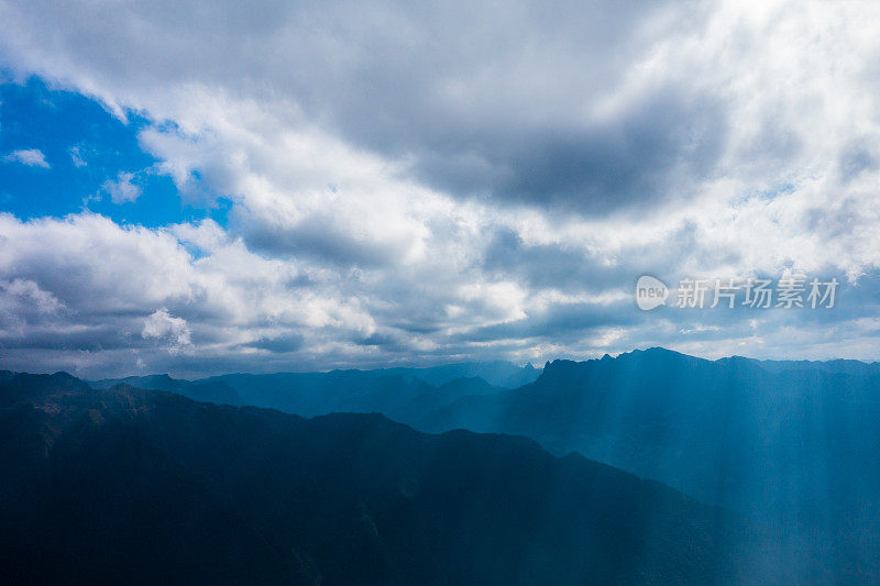 阳光透过云层在山上