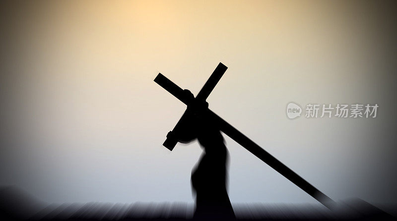 耶稣基督背着十字架，背景很淡
