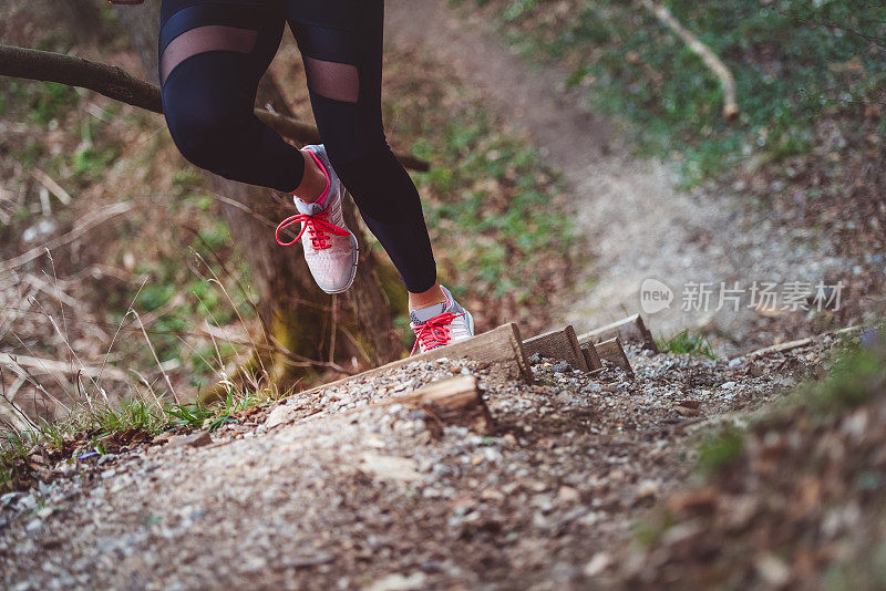 女人的腿在森林里奔跑的特写