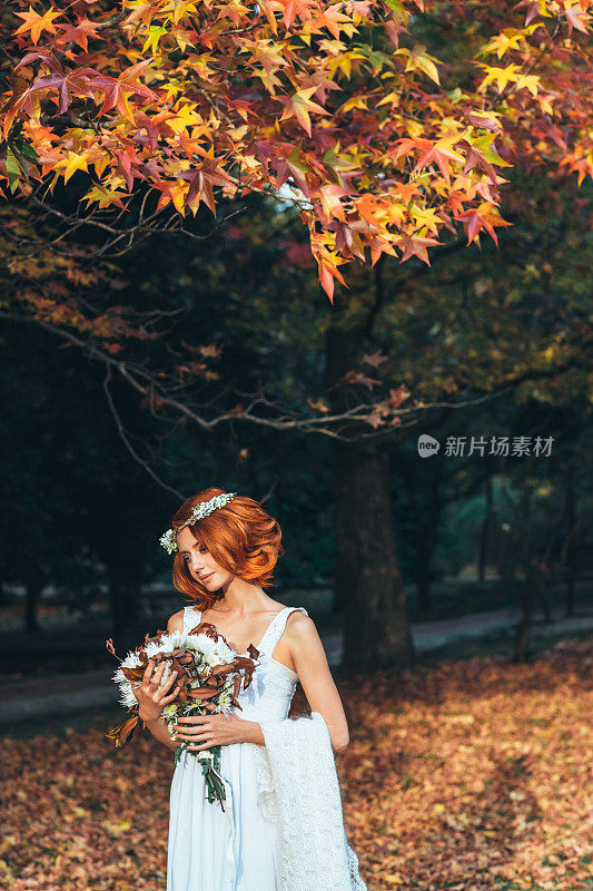 美丽的新娘在秋天的森林背景