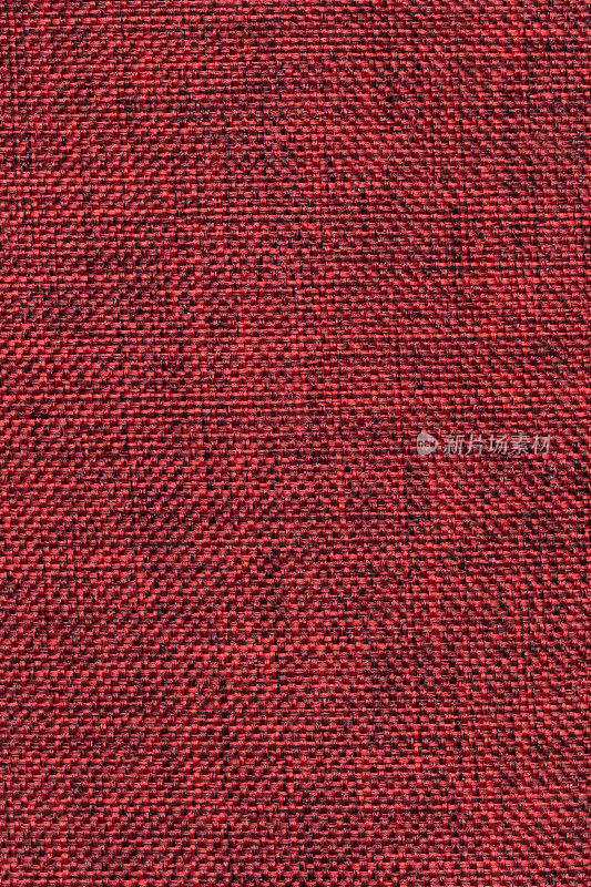 深红色织物纹理，织物背景。抽象的布纹，线织。结构的线程。粗棉麻表面。