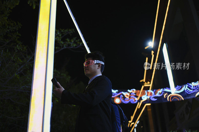 一名戴着智能眼镜的男子在夜间使用手机