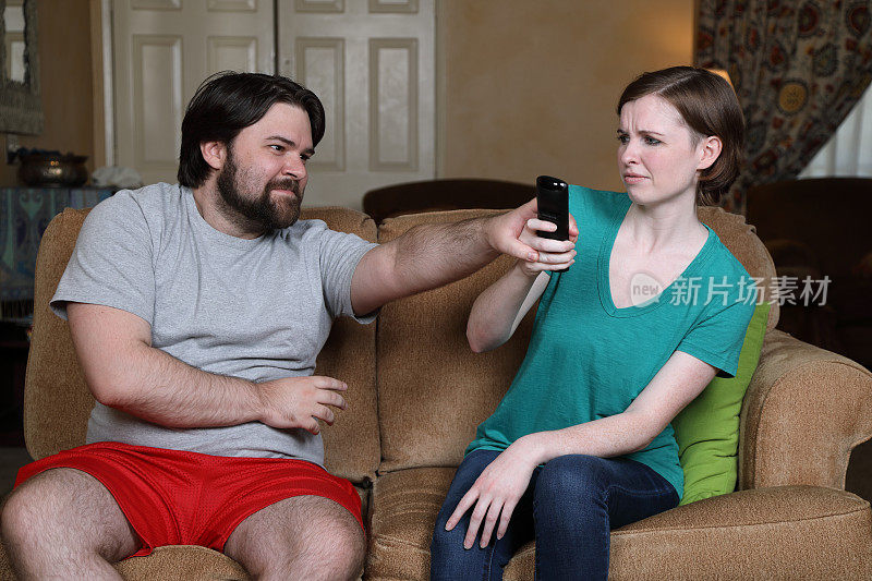 夫妻看电视时为遥控器而争吵