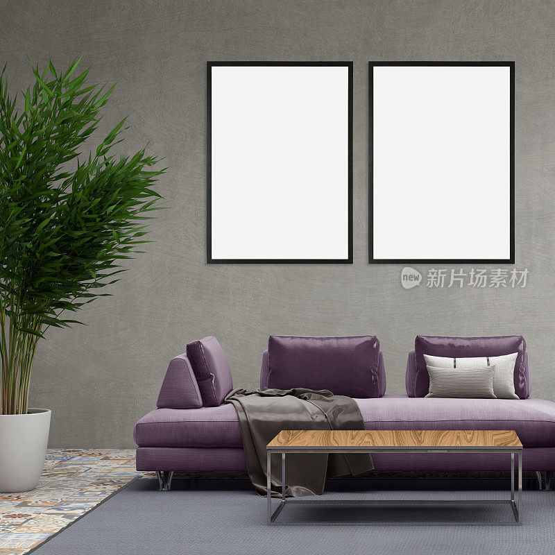 灰色的墙上挂着两个空白的相框，前面是沙发