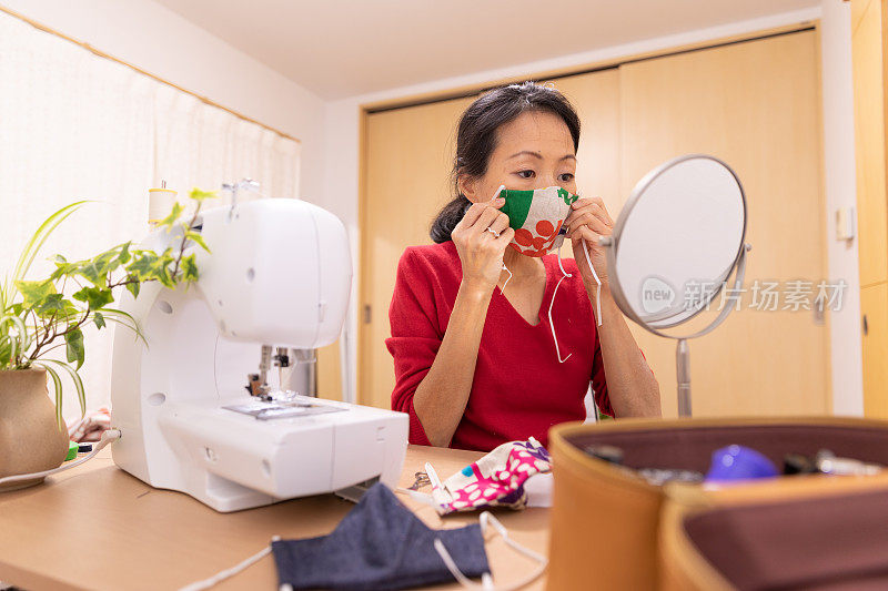 一名日本妇女在家里制作面具