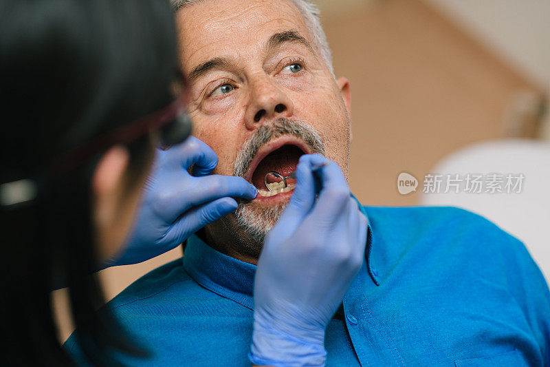 一位长者在他的牙医诊所里