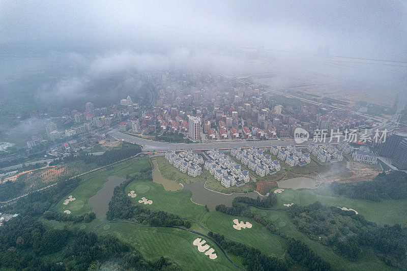 通过雾航拍拍摄的高尔夫球场