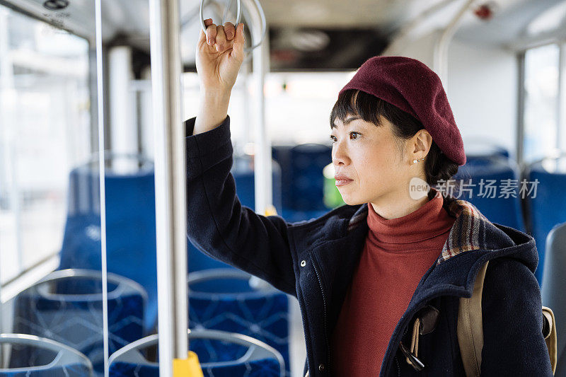 成熟的日本女性在城市里乘公交车上下班