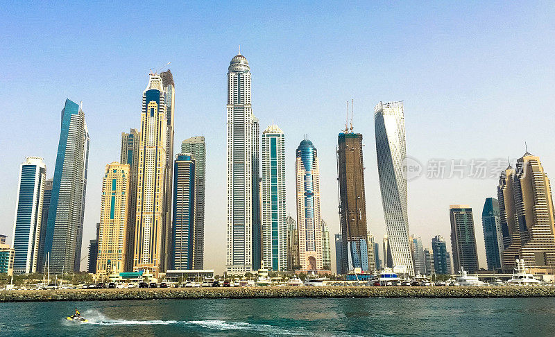 迪拜码头摩天大楼与水上滑雪者在前景